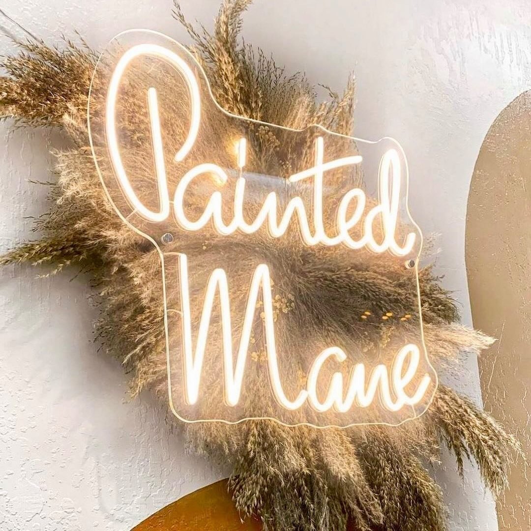 Painted Mane neon sign with pampas grass